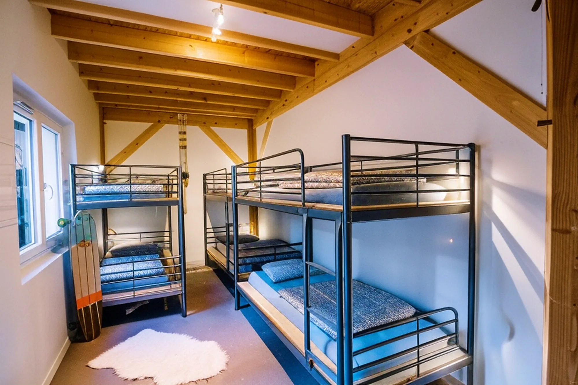 Bella dorm — bunk beds under wooden beams