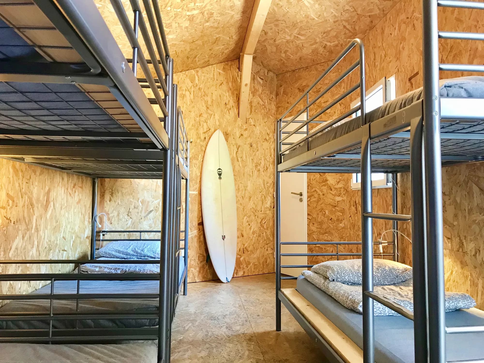 Bruce dorm — bunk beds against OSB panelled walls